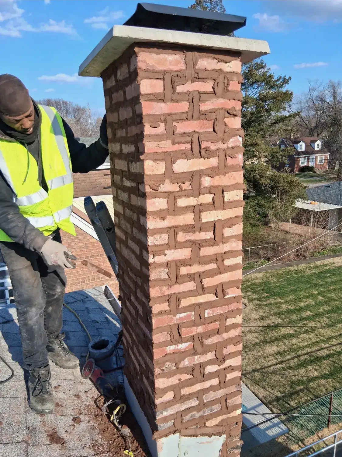 Rebuilt brick chimney with a new concrete crown