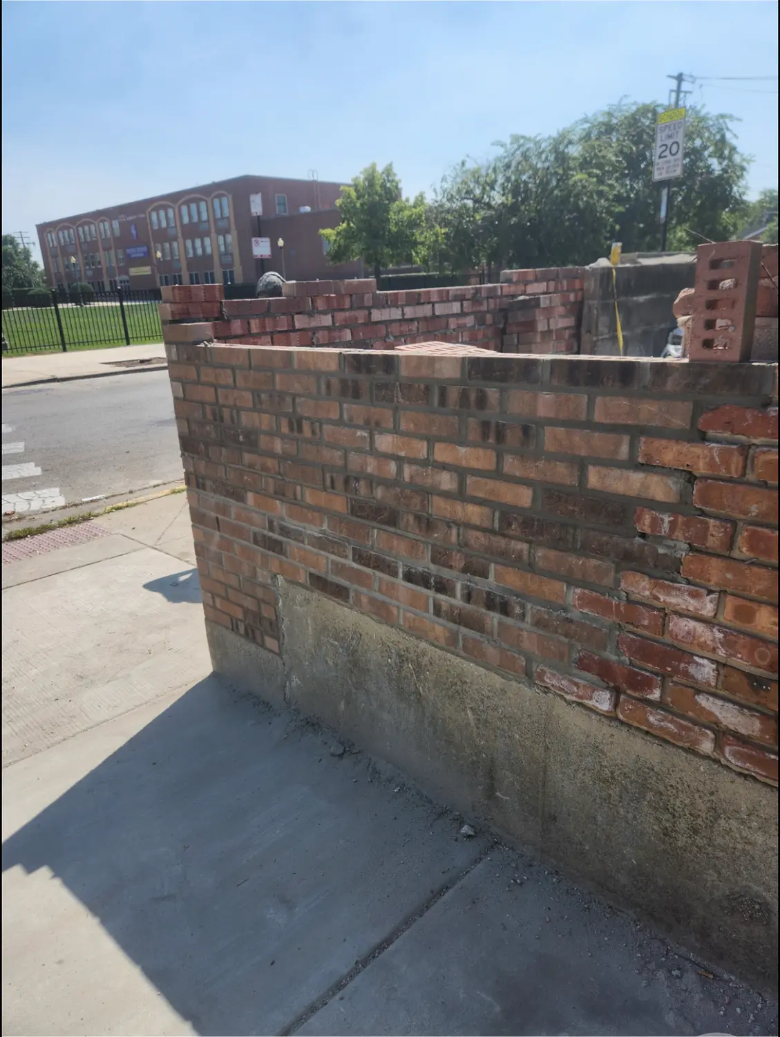 Rebuilt brick wall corner with a clean mortar finish