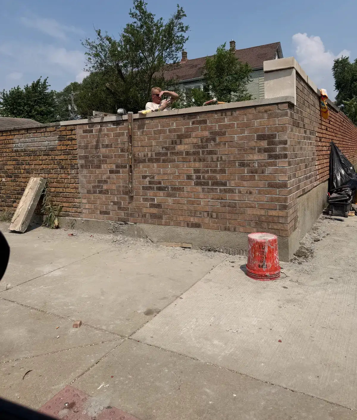 Finished brick wall with limestone coping